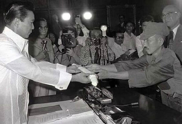 Hiroo Onoda (R) Offering His Military Sword to Philippine President Ferdinand E. Marcos (L) on the Day of His Surrender, March 11, 1974.