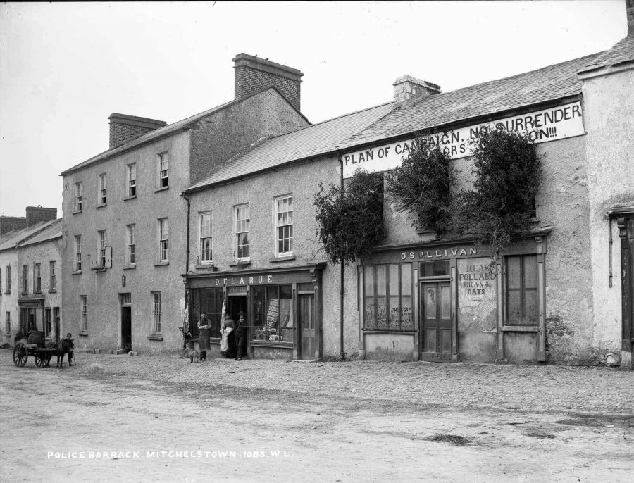 A building in Mitchelstown bears an anti-eviction banner and has its windows barricaded with brush to repel attacks.