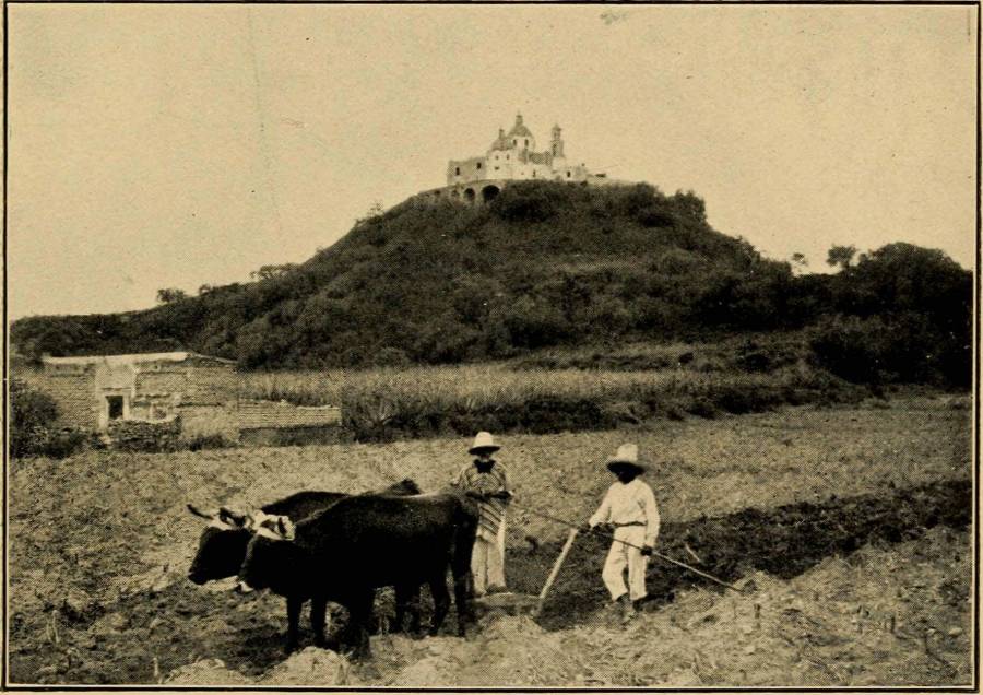 The Pyramid of  Cholula - In the foreground is a farmer using the ancient wooden plough (1909).